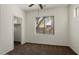 Bedroom featuring a ceiling fan, plush carpet, and a large window at 8962 W Grovers Ave, Peoria, AZ 85382