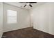 Bedroom featuring a ceiling fan, plush carpet, and a large window at 8962 W Grovers Ave, Peoria, AZ 85382
