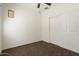 This bedroom features neutral walls, plush carpeting, and a spacious closet with sliding doors at 8962 W Grovers Ave, Peoria, AZ 85382
