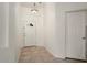 Bright entryway with neutral tile flooring, white walls, and a decorative light fixture, creating a welcoming first impression at 8962 W Grovers Ave, Peoria, AZ 85382