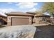 Charming home with a two-car garage, landscaped yard, and attractive architectural stone accents at 8962 W Grovers Ave, Peoria, AZ 85382