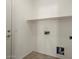 This laundry room offers tile flooring and a convenient shelving unit for storage at 8962 W Grovers Ave, Peoria, AZ 85382