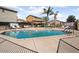 Community pool featuring lounge chairs, covered seating area, and well-maintained surroundings at 8962 W Grovers Ave, Peoria, AZ 85382