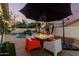 Inviting backyard seating area with a modern fire table, perfect for outdoor entertaining at 950 W Cooley Dr, Gilbert, AZ 85233