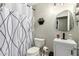 Cozy bathroom features a modern vanity with a stylish mirror and decorative shower curtain at 950 W Cooley Dr, Gilbert, AZ 85233