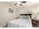 This bedroom offers wood floors, a ceiling fan, and an end table with extra shelf space at 950 W Cooley Dr, Gilbert, AZ 85233