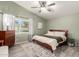 Cozy bedroom with a large window, area rug and ensuite bathroom at 950 W Cooley Dr, Gilbert, AZ 85233