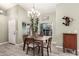 Dining room with a modern chandelier and views to the outside at 950 W Cooley Dr, Gilbert, AZ 85233