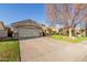 Home with a well-maintained lawn, desert landscaping, and an attached two-car garage at 950 W Cooley Dr, Gilbert, AZ 85233