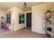 Covered front porch features a welcome mat, tile flooring, and potted plants at 950 W Cooley Dr, Gilbert, AZ 85233
