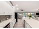 Modern open kitchen featuring stainless steel appliances, a large island, and seamless access to the living space at 950 W Cooley Dr, Gilbert, AZ 85233