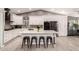 Bright kitchen features a large island with bar seating, stainless appliances, and white cabinets at 950 W Cooley Dr, Gilbert, AZ 85233