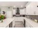 Bright kitchen with stainless steel appliances, white cabinets, and island with seating at 950 W Cooley Dr, Gilbert, AZ 85233