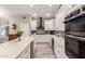 Kitchen with stainless steel appliances, white cabinets and an island with a wine fridge at 950 W Cooley Dr, Gilbert, AZ 85233