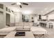Open-concept living room featuring a sectional sofa and view into the kitchen with island seating at 950 W Cooley Dr, Gilbert, AZ 85233