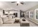 Spacious living room with a sectional sofa, access to the backyard and view of the modern kitchen at 950 W Cooley Dr, Gilbert, AZ 85233