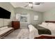 The main bedroom features modern furniture, a ceiling fan, and a window for natural light at 950 W Cooley Dr, Gilbert, AZ 85233