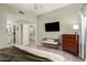 This main bedroom boasts light green walls, wood floors, and a connected bathroom and walk-in closet at 950 W Cooley Dr, Gilbert, AZ 85233