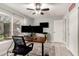 This home office includes wood floors, multiple monitors, and large windows for natural light at 950 W Cooley Dr, Gilbert, AZ 85233