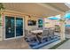 Covered outdoor dining area with seating for six and a flat screen TV at 950 W Cooley Dr, Gilbert, AZ 85233