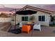 Back patio boasts a fire pit, outdoor seating and an umbrella providing shade at 950 W Cooley Dr, Gilbert, AZ 85233