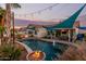 Backyard pool with a fire pit, outdoor dining area, and covered patio at 950 W Cooley Dr, Gilbert, AZ 85233