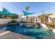 Backyard pool with waterfall features and beautiful landscaping at 950 W Cooley Dr, Gilbert, AZ 85233