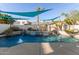Backyard pool with waterfall features and lush landscaping at 950 W Cooley Dr, Gilbert, AZ 85233