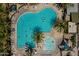 Aerial view features resort-style pool with lounge chairs under palm trees, offering ultimate relaxation at 9960 E Strobe Ave, Mesa, AZ 85212