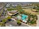 Resort-style community featuring sparkling pool, green lawn, and modern clubhouse at 9960 E Strobe Ave, Mesa, AZ 85212