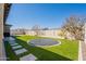 Backyard featuring artificial turf, a sunken trampoline, and lush landscaping at 9960 E Strobe Ave, Mesa, AZ 85212
