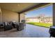 Covered outdoor patio featuring cushioned seating and a view of the lawn at 9960 E Strobe Ave, Mesa, AZ 85212