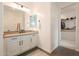 Bathroom with a white vanity, walk in closet, and a view of the modern glass-enclosed shower at 9960 E Strobe Ave, Mesa, AZ 85212