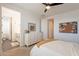 Bedroom featuring a dresser with decorative mirror and a view into the bathroom at 9960 E Strobe Ave, Mesa, AZ 85212