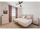Inviting bedroom featuring a double bed setup, stylish decor, and a ceiling fan for optimal comfort at 9960 E Strobe Ave, Mesa, AZ 85212