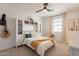 Comfortable bedroom with a hanging chair, a full bookcase, and natural light from the window at 9960 E Strobe Ave, Mesa, AZ 85212