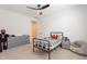 Well-lit bedroom with a sports theme, featuring a ceiling fan and neutral walls that create a peaceful environment at 9960 E Strobe Ave, Mesa, AZ 85212