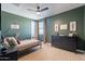 A cozy bedroom with stylish decor, a modern ceiling fan, and a large dresser for ample storage at 9960 E Strobe Ave, Mesa, AZ 85212