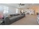 Large open bonus room with a modular sofa, play area, and comfortable seating at 9960 E Strobe Ave, Mesa, AZ 85212