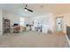 Expansive bonus room featuring a built-in desk, shelving, and a ceiling fan for comfortable living and entertaining at 9960 E Strobe Ave, Mesa, AZ 85212