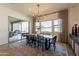 Elegant dining room with wooden table, modern chandelier, and sliding glass door to the patio at 9960 E Strobe Ave, Mesa, AZ 85212
