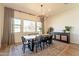 Dining room with large windows providing natural light, a rustic wooden table, and decorative accents at 9960 E Strobe Ave, Mesa, AZ 85212