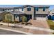 A charming two-story home with a brick driveway and two-car garage, enhanced by beautiful landscaping at 9960 E Strobe Ave, Mesa, AZ 85212
