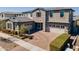 A charming two-story home with a brick driveway and two-car garage, enhanced by beautiful landscaping at 9960 E Strobe Ave, Mesa, AZ 85212