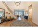 Spacious foyer with a staircase, hardwood floors, and view into the living and dining area at 9960 E Strobe Ave, Mesa, AZ 85212