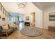 Spacious foyer with a staircase, hardwood floors, and view into the living and dining area at 9960 E Strobe Ave, Mesa, AZ 85212