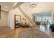 Gracious foyer with grand staircase, chandelier, and views into the spacious living areas at 9960 E Strobe Ave, Mesa, AZ 85212