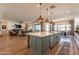 Open-concept kitchen featuring an island with seating, modern appliances, and a view into the living area at 9960 E Strobe Ave, Mesa, AZ 85212