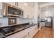 Well-equipped kitchen with stainless steel appliances, white cabinets, and dark countertops at 9960 E Strobe Ave, Mesa, AZ 85212