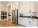 Well-lit kitchen featuring stainless steel appliances, ample counter space, and white cabinets at 9960 E Strobe Ave, Mesa, AZ 85212